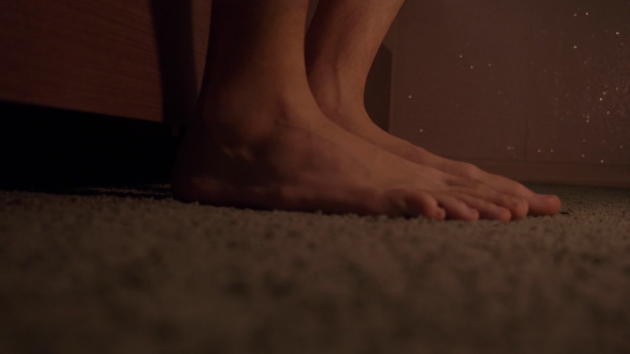 A person wakes up early in the morning. Bare feet touch soft carpet. Sunlight pours in through a window. The day begins with new possibilities ahead.