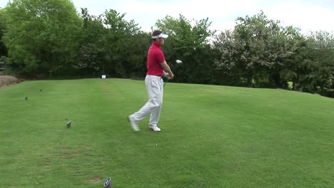 a man teeing off in golf