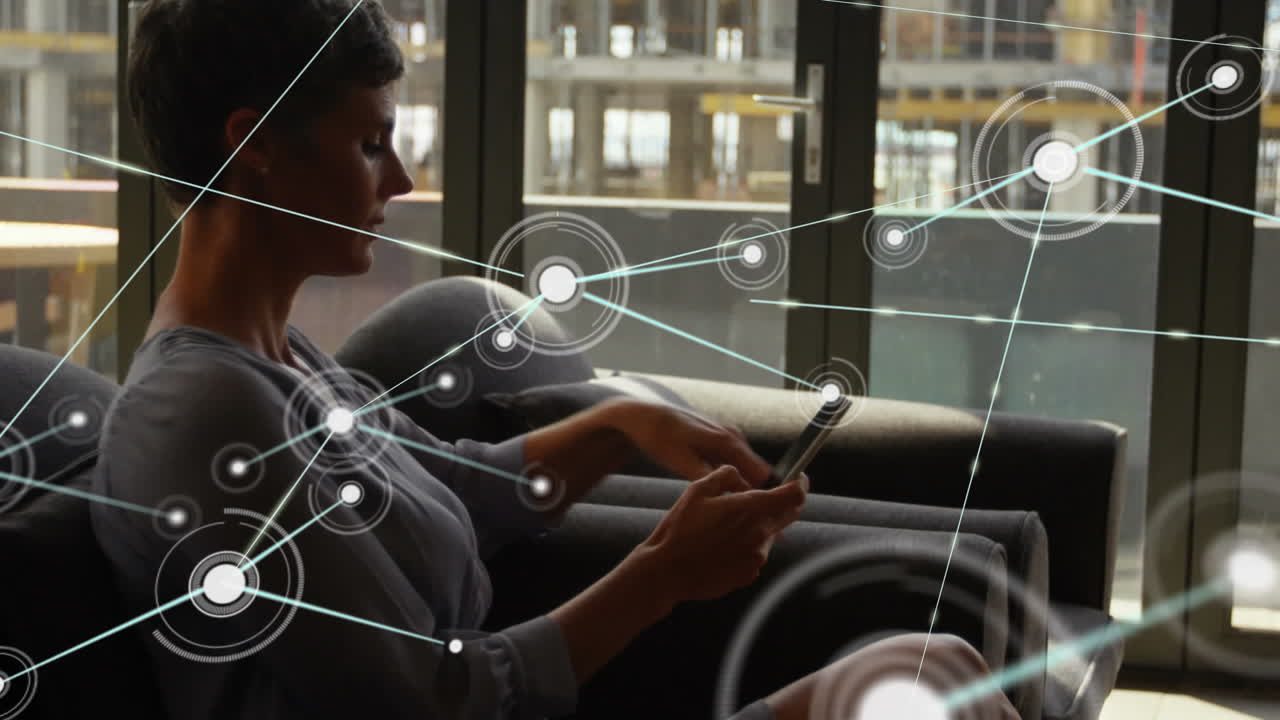 Animation of network of connections over caucasian businesswoman using smartphone