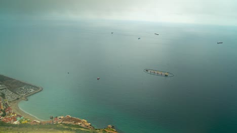 floating farm and industrial port of gibraltar coast, time lapse from above