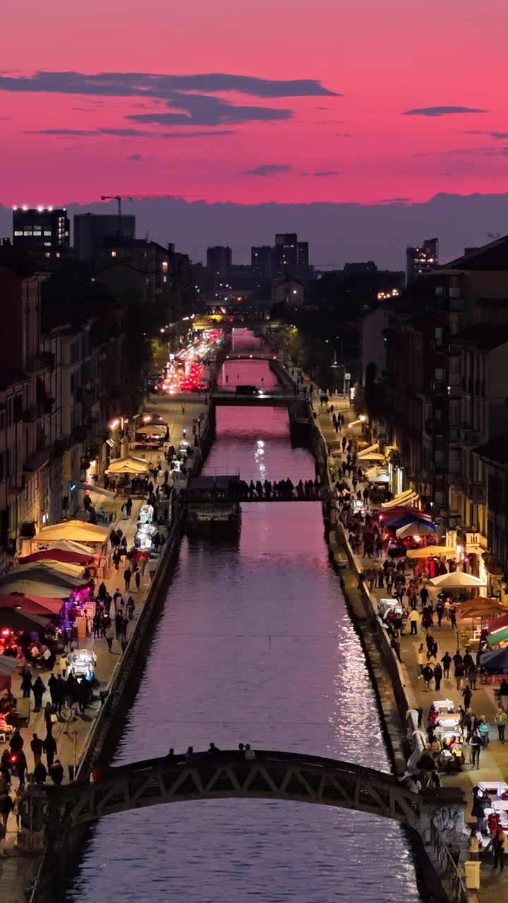 Aerial drone view of the Naviglio Grande canal at sunset. Vertical