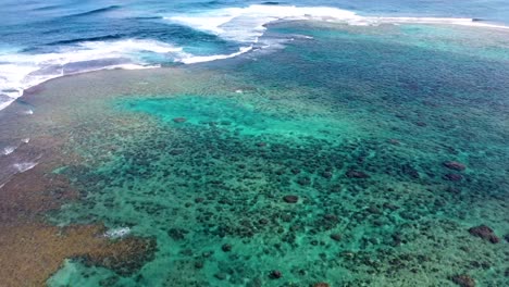 aerial view of waves crashing over tropical coral reef in kauai, hawaii, usa