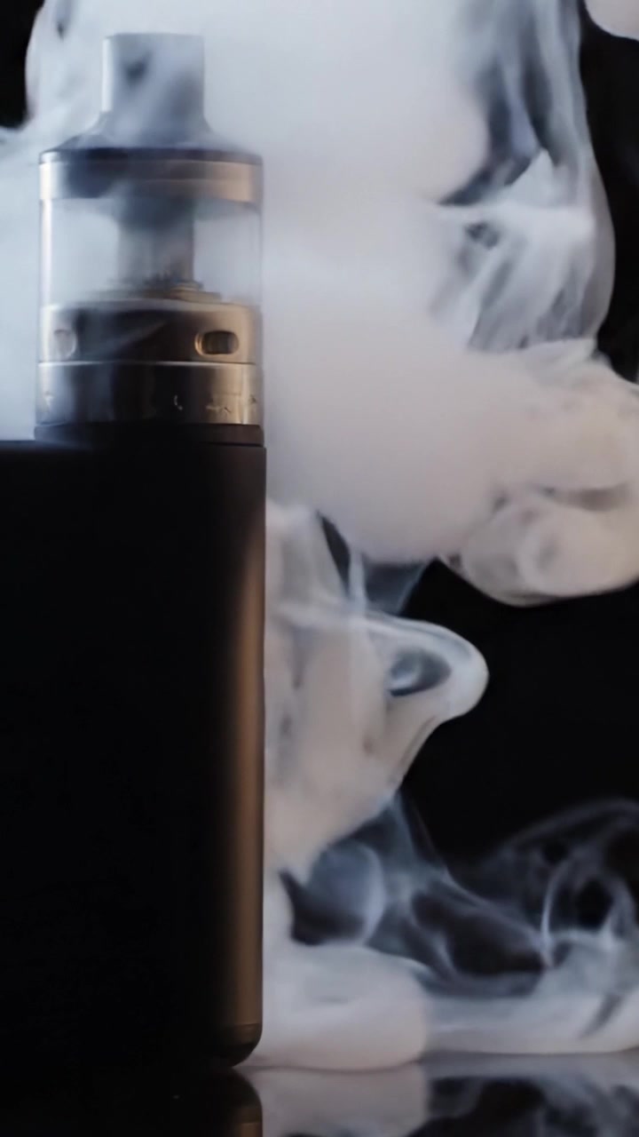 Stylish Vape Device Surrounded by Cloudy Vapor, Capturing the Essence of Modern Vaping Culture and Its Unique Aesthetic Appeal