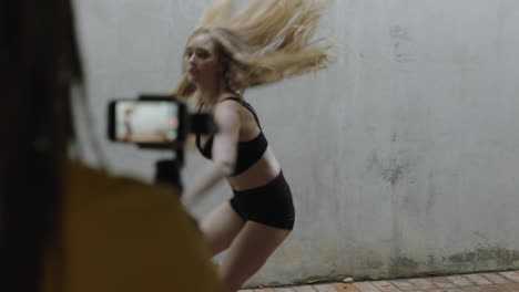 dancing woman young caucasian freestyle dancer performing for friend using smartphone taking video enjoying sharing hip hop dance on social media