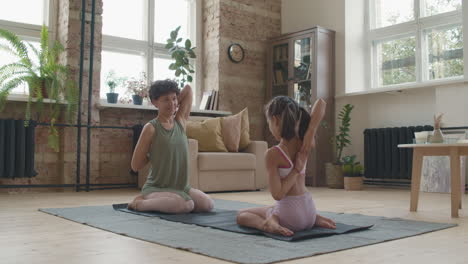 mother and daughter practicing yoga at home