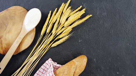 Baguette-wrapped-in-napkin-and-wheat-grains