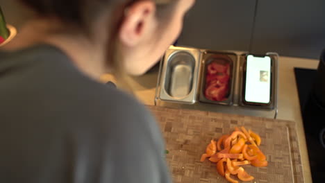 over the shoulder shot of female hands slicing green bean