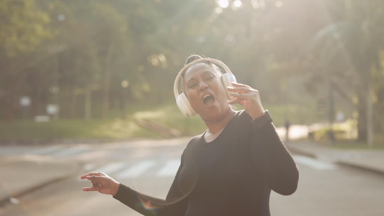 Woman listening to music and enjoying herself in the park