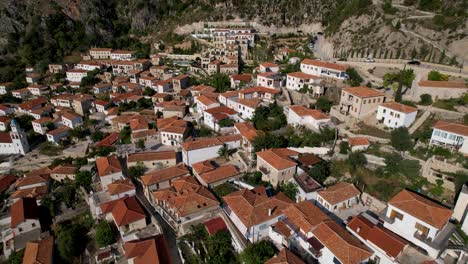 albanian village on mountains of ionian shoreline with red roof houses reconstructed and narrow alleys paved on cobblestones