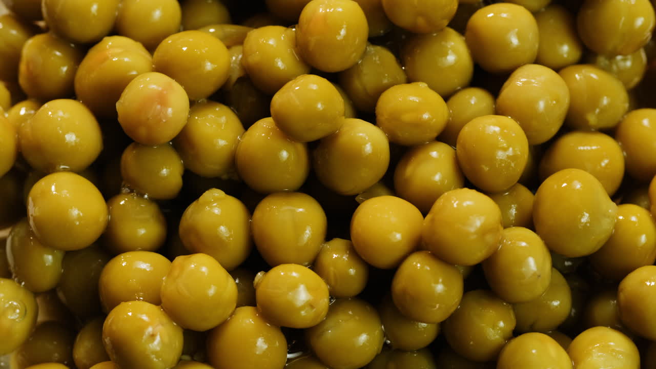 marinated pickled sweet green peas, rotation in circle. Take canned green pea kernels with a fork. High quality 4k footage
