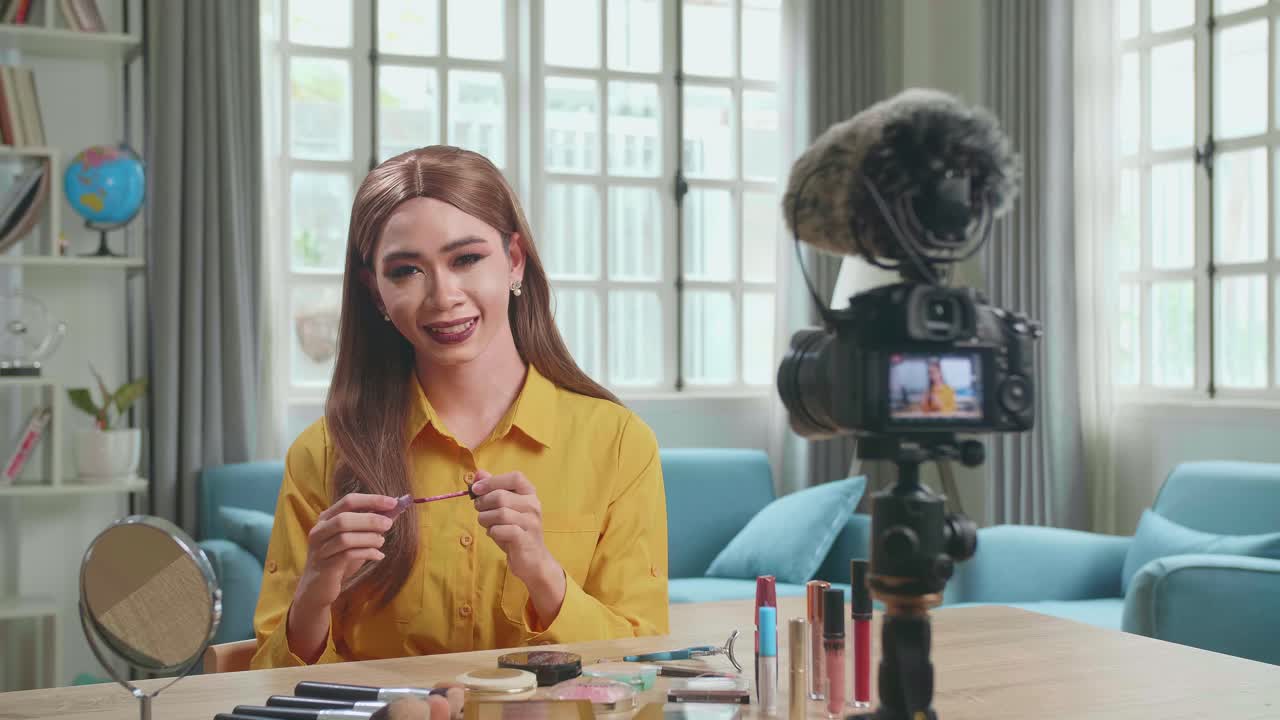 Influencer Young Transgender Woman Blogger Makeup. Transgender Woman Looks And Smiles To Camera In Home Studio