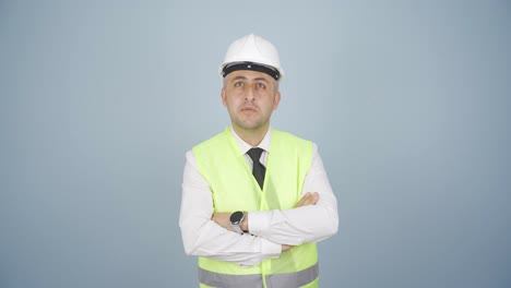 Looking-up,-the-engineer-is-holding-his-hard-hat.