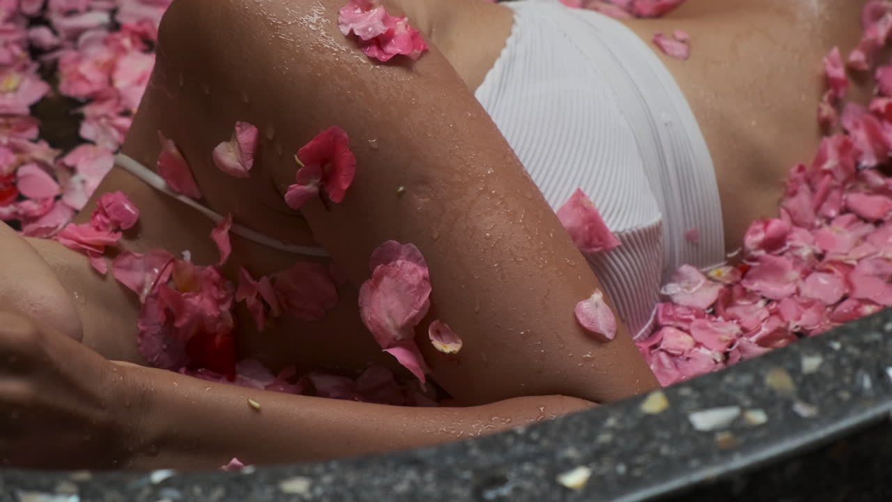 Woman Relaxing in a Rose Petal Bath