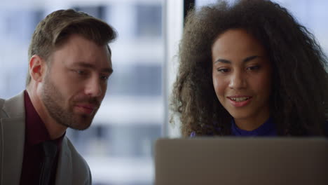 Multiethnic business couple working on computer laptop