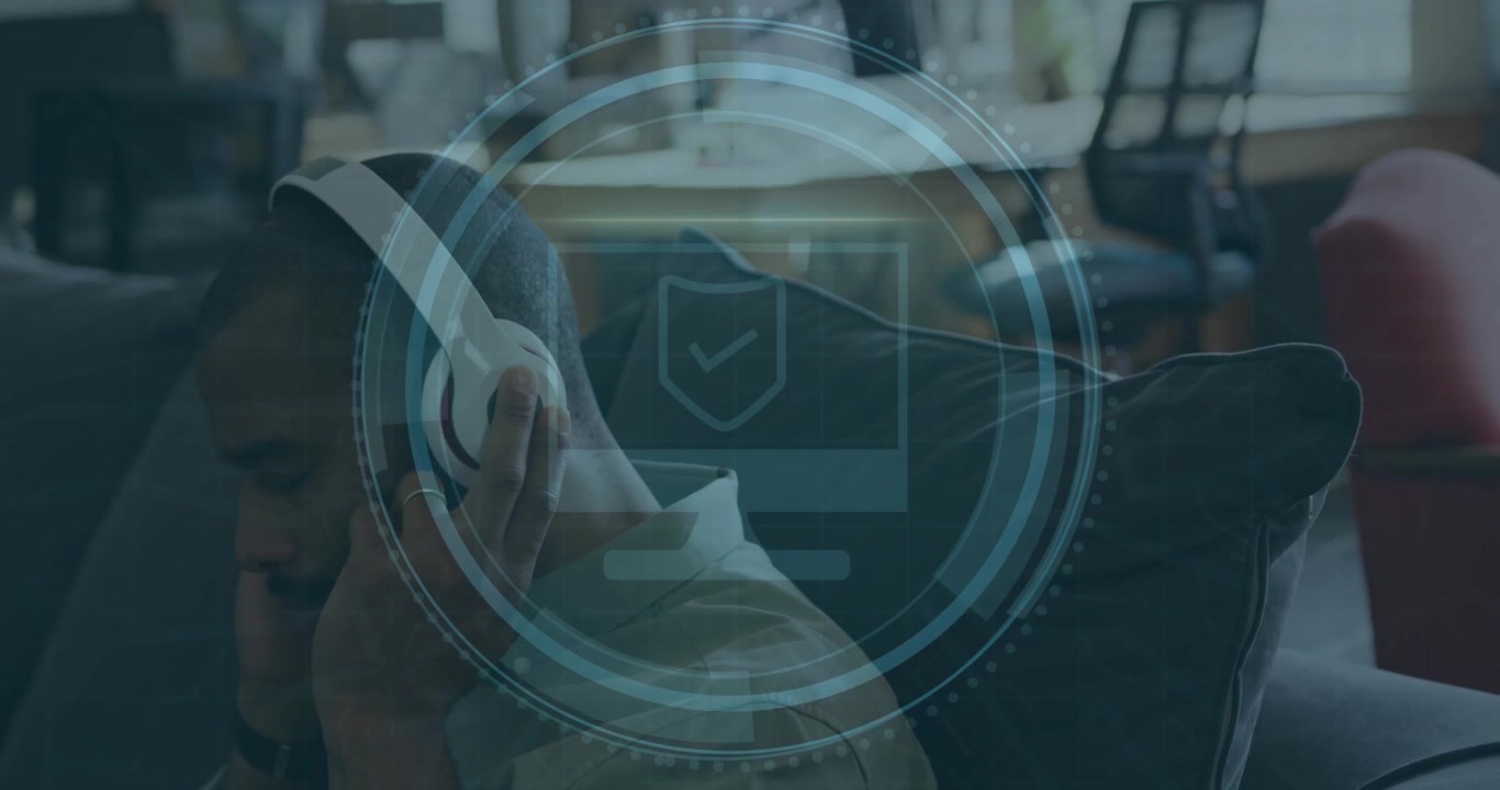 Man placing headphone while holding smartphone, initiating cyber security scan with pulsing shield