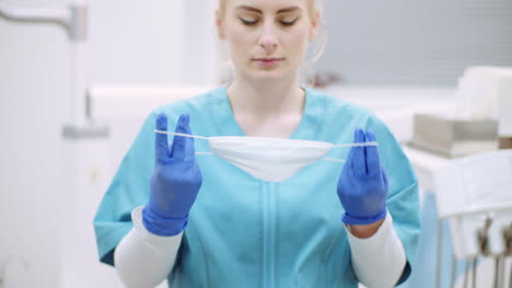 dentista poniéndose una máscara protectora antes de la cirugía 1
