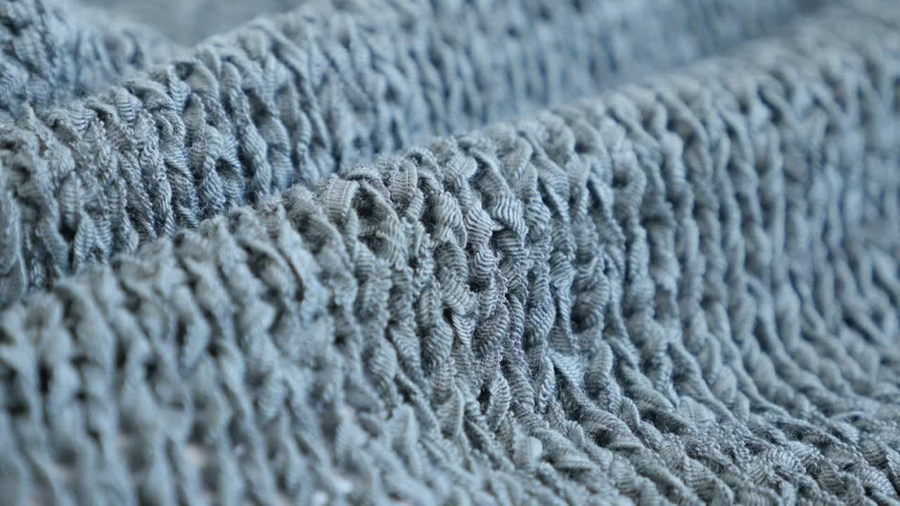 Shallow DOF knitting made sweater texture details slow tilt 4K 2160p 30fps UltraHD  footage - Close-up of fine green knitwork fine texture  3840X2160 UHD tilting video