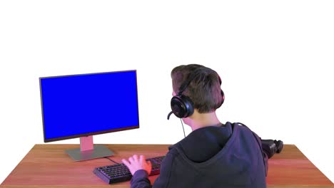 back shot of competitive young man playing online games on computer on white background