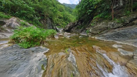 fpv drone shot over rapids, in middle of jungle in las yayitas, dominican republic