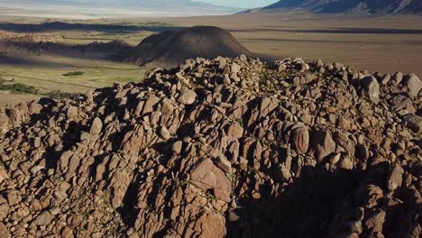 cinematic aerial view on rocky formation in valley under alabama hills, california