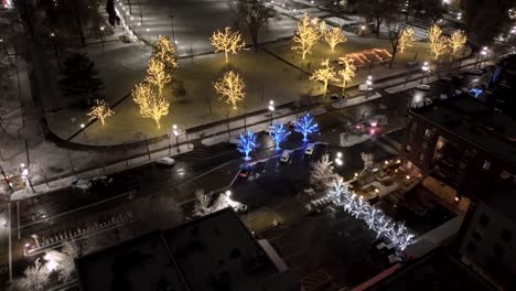 city park decorated with christmas lights - pullback aerial