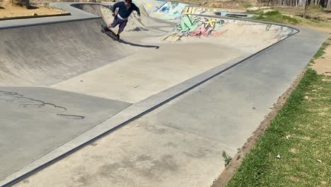 professional skater in bowl skatepark doing tricks, skateboarder carving a turn in a deep concrete bowl, young man on extreme surfboard, summer sports