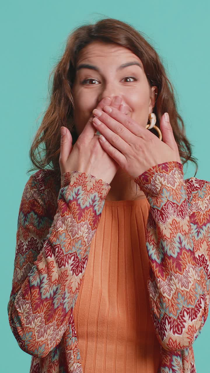 Frightened woman closing mouth with hands refusing to tell terrible secret unbelievable truth