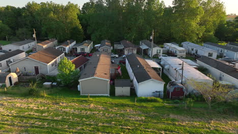 aerial pull back from american flag crammed between packed mobile homes