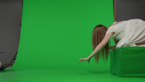 fullsize side view green screen chroma key video of a posessed female figure ghost - full-size side view green screen, chroma key video of a posessed female figure, ghost, poltergeist, zombie pulling her hands out. hair is covering her face. horror clip, advertisement, dead. chroma key