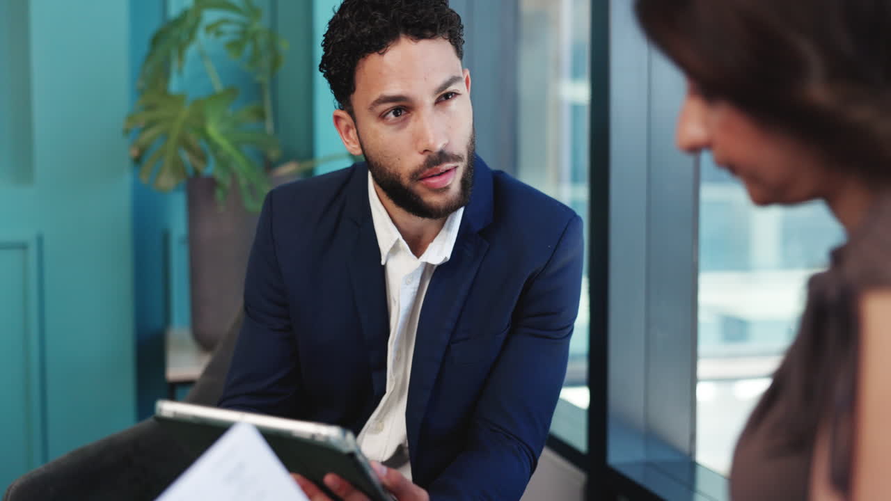Businessman Discussing Data with Colleague in Modern Office