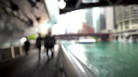 out of focus view of people walking in chicago riverwalk