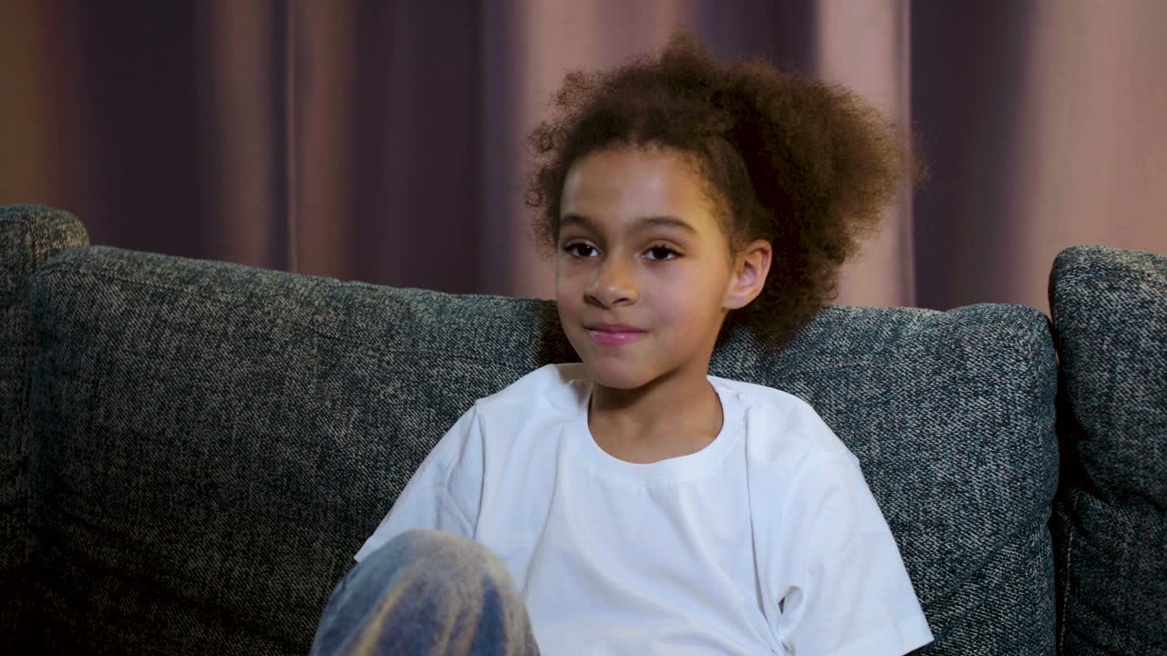 Kid watching film at home