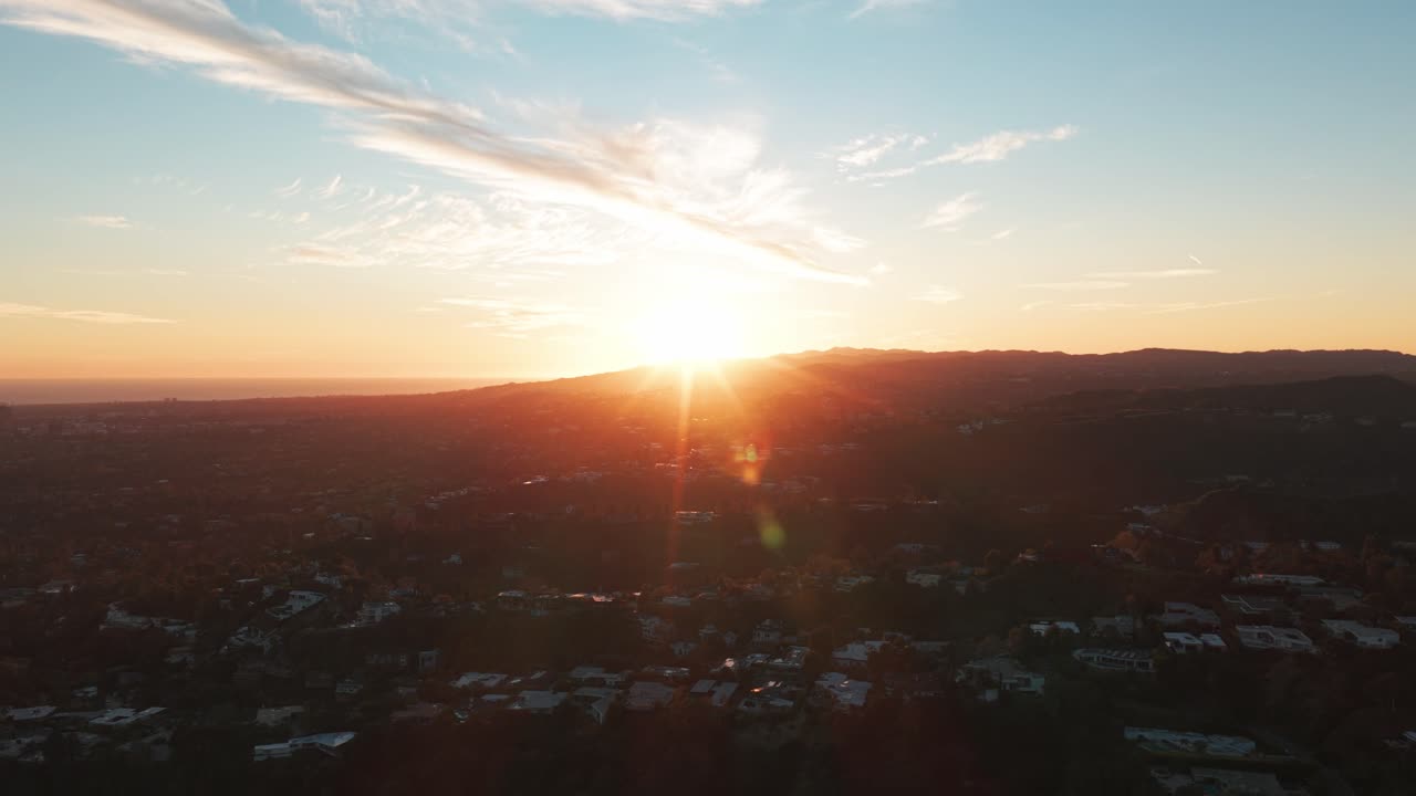 Wide dolly shot of the sun setting over Beverly Hills in Southern California. 4K