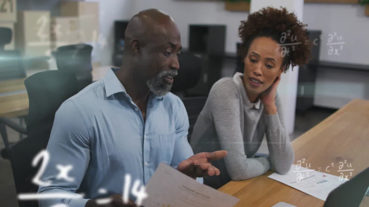 Vertical video: Business team reviewing docs, woman pointing at laptop, man explaining math overlay