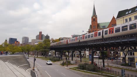 metro on elevated tracks in hamburg city driving towards on overcast autumn day