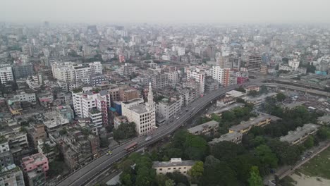 highway road leading through dhaka city downtown, aerial orbit view