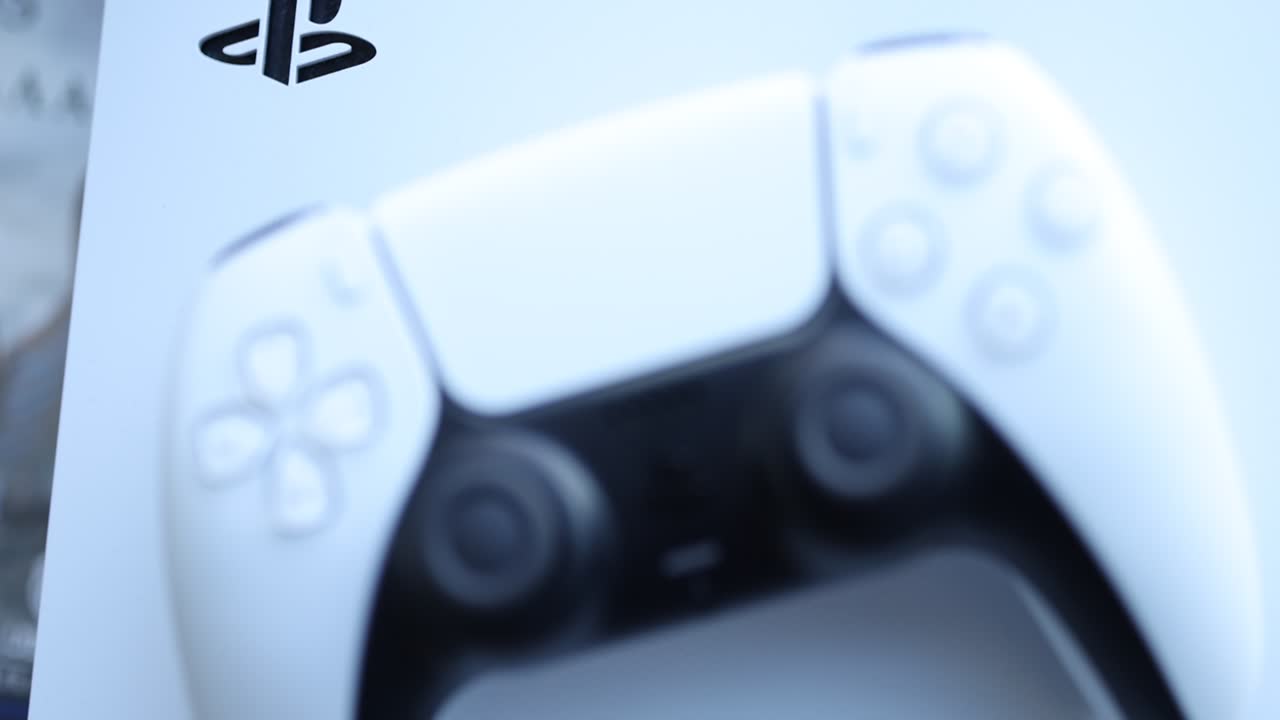 Close-up of a white PlayStation 5 DualSense controller