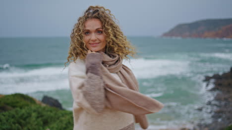 happy lady enjoy seascape at cloudy weekend close up. smiling woman on seashore