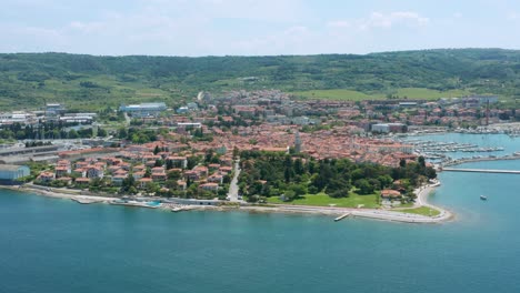 Bird's-Eye-View-Of-Izola-Beach,-Town,-And-Marina-On-A-Sunny-Summer-Day-In-Istria,-Slovenia