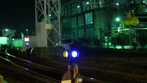 shot of railroad and signal in an industrial area at night in kawasaki, japan