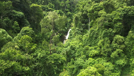 Aerial-pan-left-of-Huay-To-Waterfall-among-lush-vegetation-on-sunny-day,-Krabi