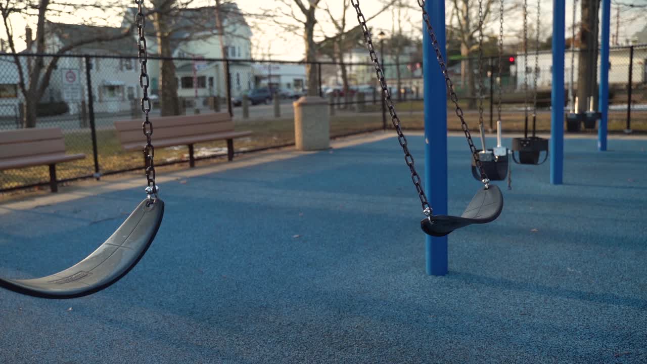 Swing Set At Playground Swinging In Slow Motion