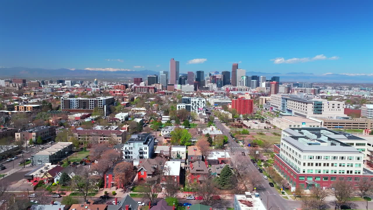 City Park Lodo Downtown Denver Cityscape Landscape Colorado aerial drone view tall skyscraper buildings neighborhood Wash Park city living apartments spring summer front range mountains upwards motion