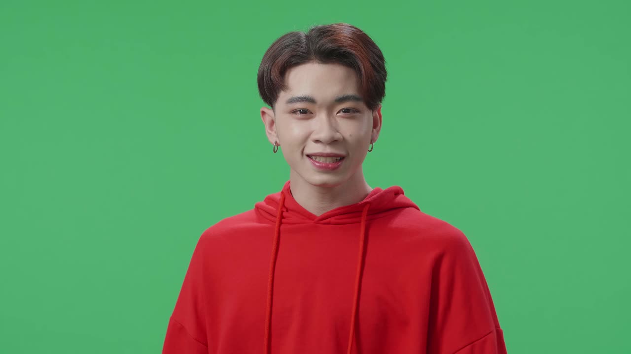 Angry Asian Transgender Male Scolding While Standing On Green Screen In The Studio