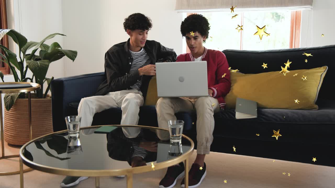 Left man pointing at tablet right man using laptop studying screen gold stars appearing over group