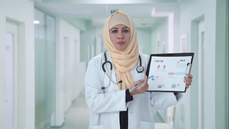 happy muslim doctor explaining reports to patient