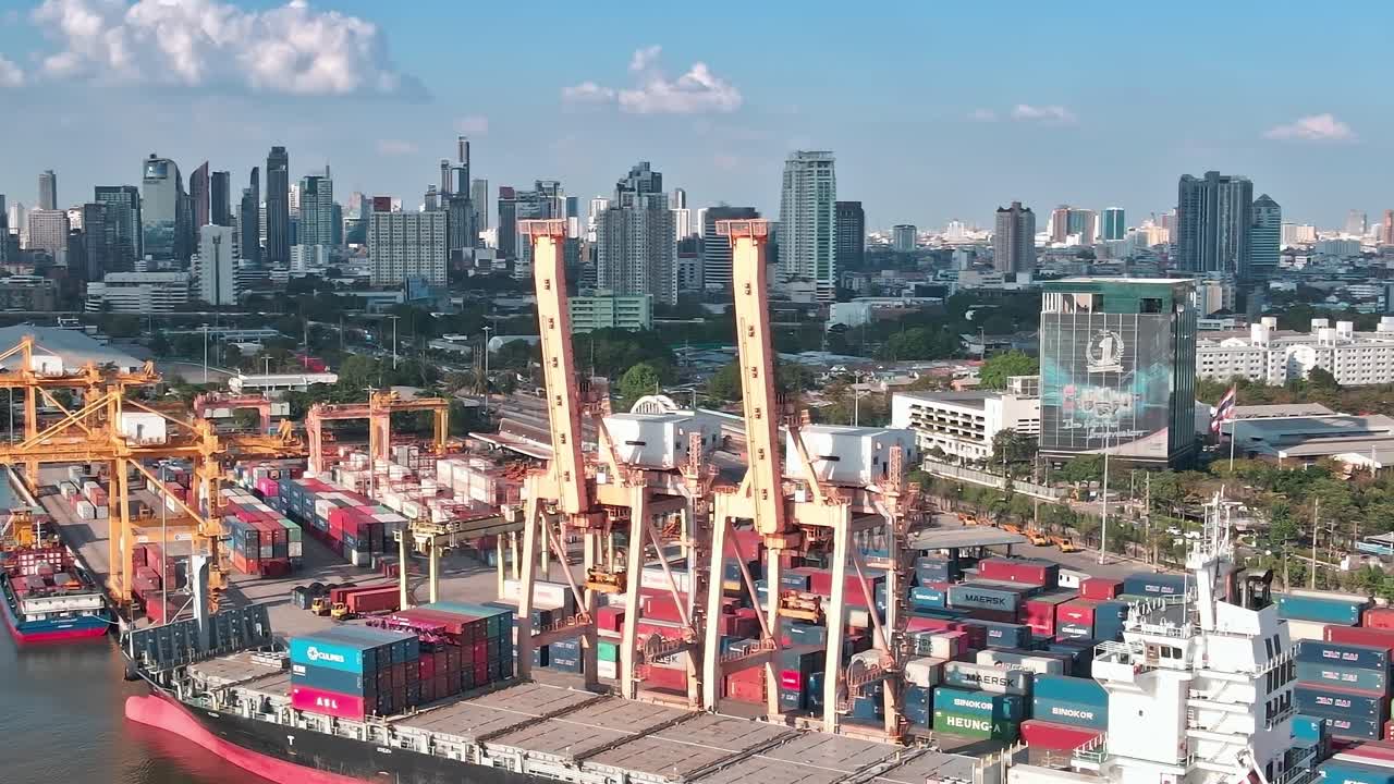 Aerial view of cargo docks with Bangkok skyline in the background