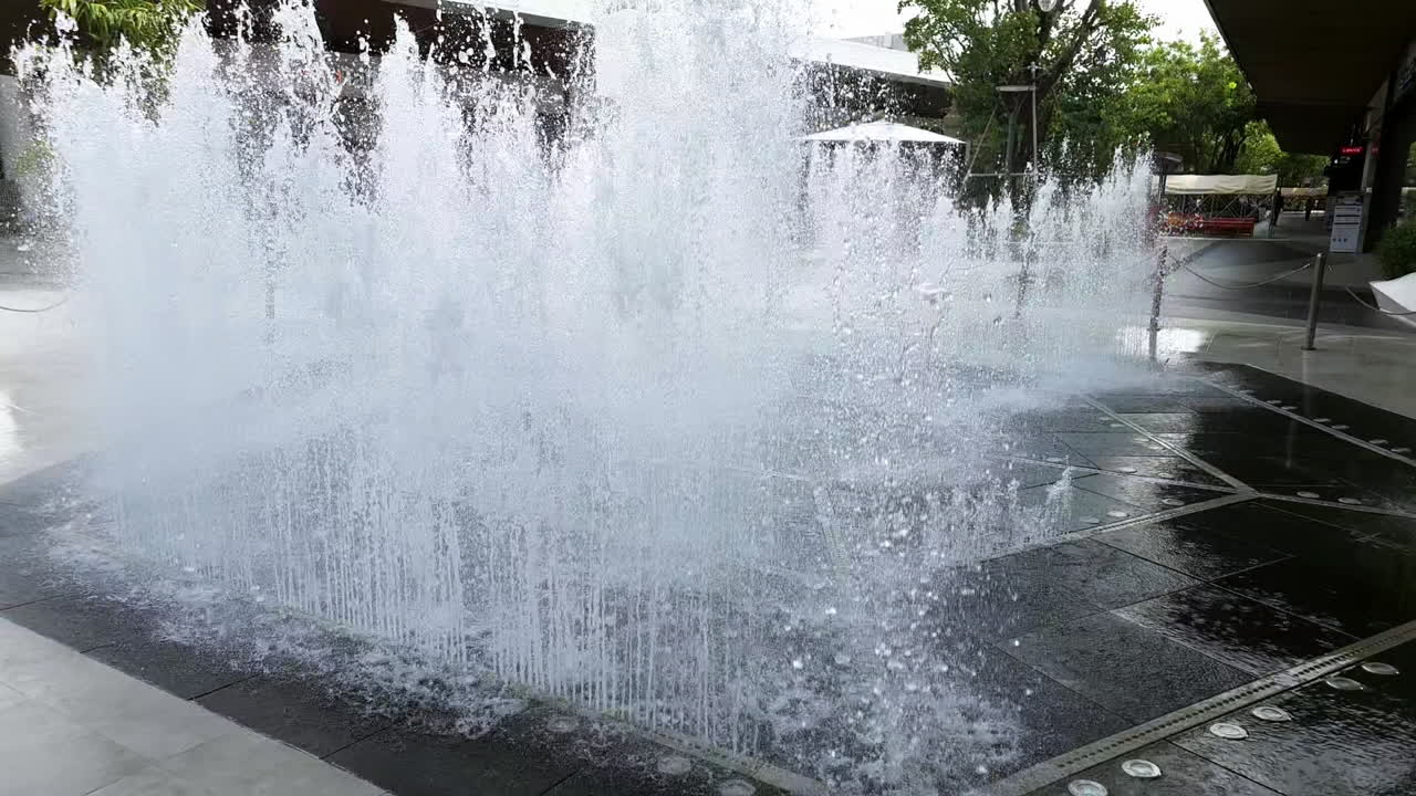 Water fountain bursting with fresh water in the middle of a community mall center in Bangkok, Thailand