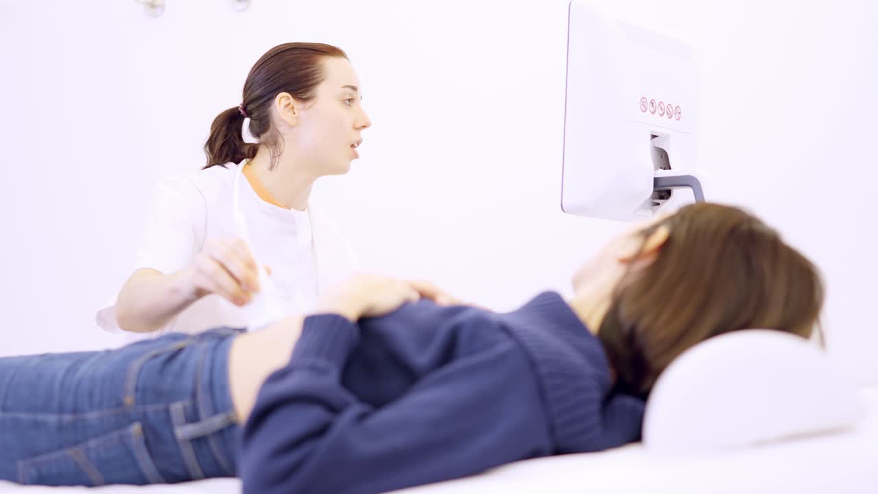 Doctor performing an ultrasound on a woman in the clinic