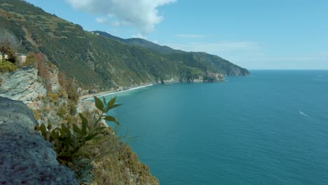 Cinque-Terre-Corniglia-Parallax-Coastal-View-with-Clouds,-Horizon,-Italy,-Lush-Vegetation